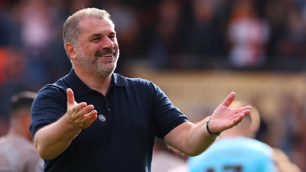 Tottenham Hotspur manager Ange Postecoglou pictured celebrating in front of his team's fans after a 1-0 win at Luton Town in October 2023